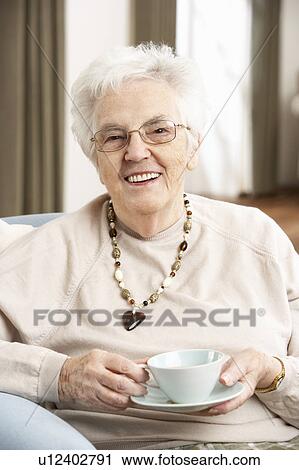 Senior Woman Enjoying Cup Of Tea At Home View Large Photo Image Stock Image - Senior Woman Enjoying Cup Of Tea At Home. Fotosearch