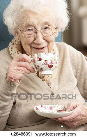 Senior Woman Enjoying Cup Of Tea At Home View Large Photo Image Stock Image - Senior Woman Enjoying Cup Of Tea At Home. Fotosearch