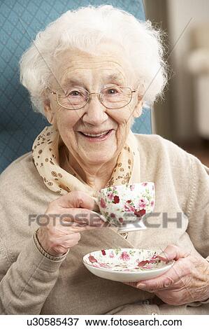 Stock Photo - Senior Woman Enjoying Cup Of Tea At Home. Fotosearch