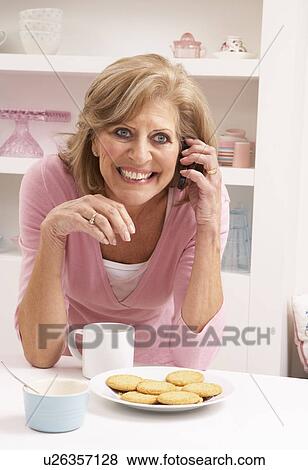 Senior Woman Enjoying Hot Drink Whilst On Phone View Large Photo Image Stock Photo - Senior Woman Enjoying Hot Drink Whilst On Phone. Fotosearch