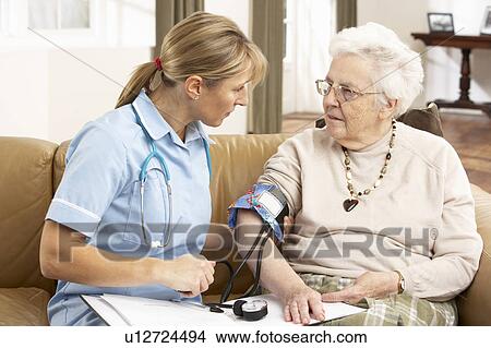 Senior Woman having Blood Pressure Taken By Health Visitor At Home View Large Photo Image Picture - Senior Woman having Blood Pressure Taken By Health Visitor At Home. Fotosearch