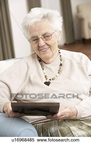 Senior Woman Looking At Photograph In Frame View Large Photo Image Stock Photography - Senior Woman Looking At Photograph In Frame. Fotosearch