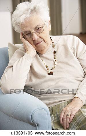 Senior Woman Looking Sad In Chair At Home View Large Photo Image Stock Image - Senior Woman Looking Sad In Chair At Home. Fotosearch