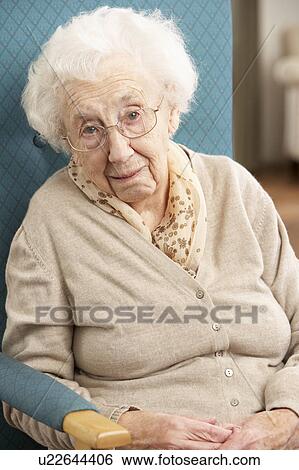 Senior Woman Looking Sad In Chair At Home View Large Photo Image Stock Photograph - Senior Woman Looking Sad In Chair At Home. Fotosearch