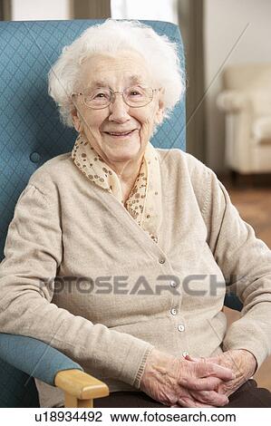 Senior Woman Relaxing In Chair At Home View Large Photo Image Stock Image - Senior Woman Relaxing In Chair At Home. Fotosearch