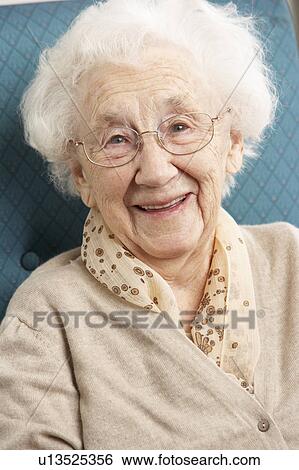 Senior Woman Relaxing In Chair At Home View Large Photo Image Stock Photograph - Senior Woman Relaxing In Chair At Home. Fotosearch