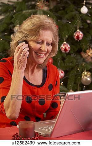 Senior Woman Shopping Online For Christmas Gifts On Phone View Large Photo Image Stock Photo - Senior Woman Shopping Online For Christmas Gifts On Phone. Fotosearch