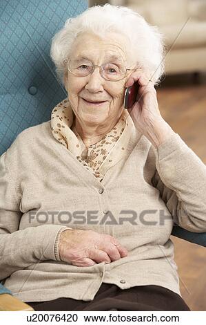 Senior Woman Talking On Mobile Phone Sitting In Chair At Home View Large Photo Image Stock Image - Senior Woman Talking On Mobile Phone Sitting In Chair At Home. Fotosearch