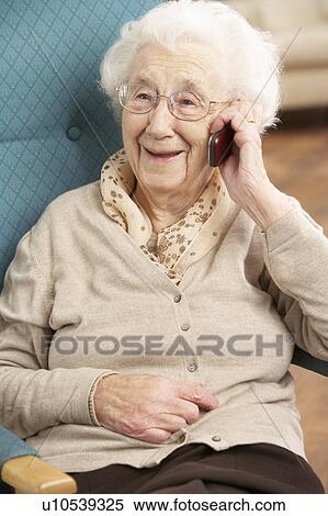 Senior Woman Talking On Mobile Phone Sitting In Chair At Home View Large Photo Image Stock Photography - Senior Woman Talking On Mobile Phone Sitting In Chair At Home. Fotosearch