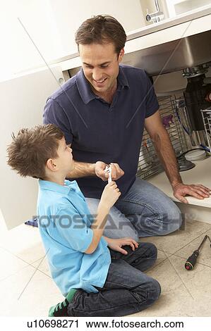 Son Helping Father To Mend Sink In Kitchen View Large Photo Image Stock Image - Son Helping Father To Mend Sink In Kitchen. Fotosearch