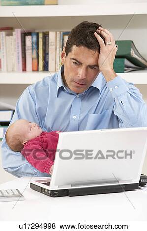 Stressed Father With Newborn Baby Working From Home Using Laptop View Large Photo Image Stock Photo - Stressed Father With Newborn Baby Working From Home Using Laptop. Fotosearch