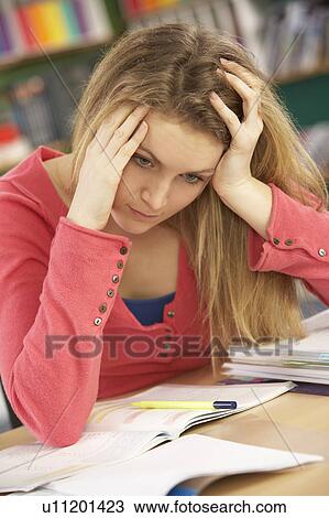 Stressed Female Teenage Student Studying In Classroom View Large Photo Image Stock Image - Stressed Female Teenage Student Studying In Classroom. Fotosearch