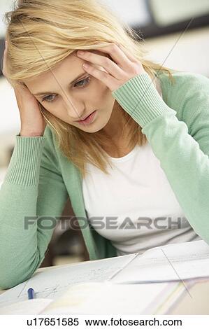 Stock Photography - Stressed Female Teenage Student Studying In Classroom. Fotosearch