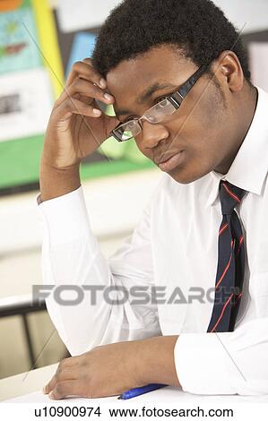 Stressed Male Teenage Student Studying In Classroom View Large Photo Image Picture - Stressed Male Teenage Student Studying In Classroom. Fotosearch