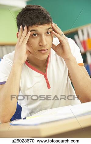 Stressed Male Teenage Student Studying In Classroom View Large Photo Image Stock Image - Stressed Male Teenage Student Studying In Classroom. Fotosearch