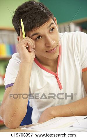 Stressed Male Teenage Student Studying In Classroom View Large Photo Image Stock Photo - Stressed Male Teenage Student Studying In Classroom. Fotosearch