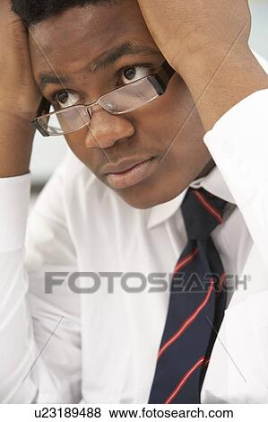Stock Photo - Stressed Male Teenage Student Studying In Classroom. Fotosearch