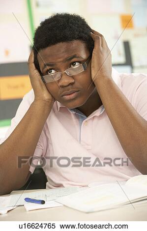 Stressed Male Teenage Student Studying In Classroom View Large Photo Image Stock Photography - Stressed Male Teenage Student Studying In Classroom. Fotosearch