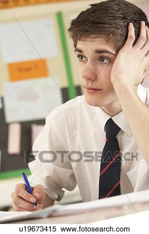 Stressed Male Teenage Student Studying In Classroom View Large Photo Image Stock Photography - Stressed Male Teenage Student Studying In Classroom. Fotosearch