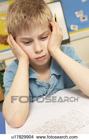 Stressed Schoolboy Studying In Classroom View Large Photo Image Picture - Stressed Schoolboy Studying In Classroom. Fotosearch