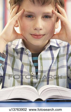 Stressed Schoolboy Studying In Classroom View Large Photo Image Stock Image - Stressed Schoolboy Studying In Classroom. Fotosearch