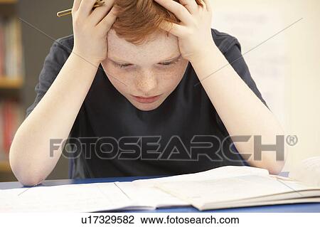 Stressed Schoolboy Studying In Classroom View Large Photo Image Stock Image - Stressed Schoolboy Studying In Classroom. Fotosearch