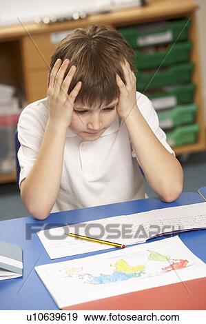 Stressed Schoolboy Studying In Classroom View Large Photo Image Stock Photo - Stressed Schoolboy Studying In Classroom. Fotosearch