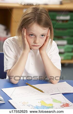 Stock Photography - Stressed Schoolgirl Studying In Classroom. Fotosearch