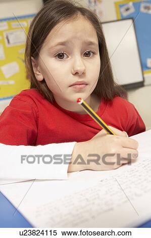 Stock Photography - Stressed Schoolgirl Studying In Classroom. Fotosearch