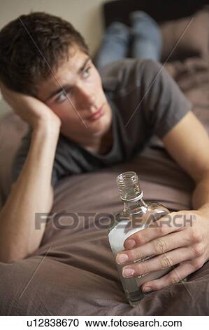 Teenage Boy Lying In Bedroom Drinking View Large Photo Image Stock Image - Teenage Boy Lying In Bedroom Drinking. Fotosearch