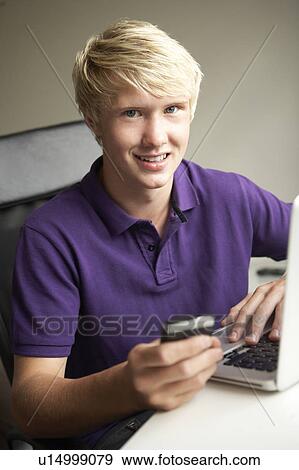 Stock Photo - Teenage Boy Lying In Bedroom Drinking. Fotosearch