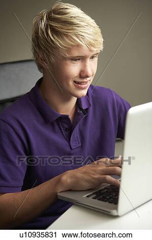Teenage Boy Using Laptop At Home View Large Photo Image Stock Image - Teenage Boy Using Laptop At Home. Fotosearch
