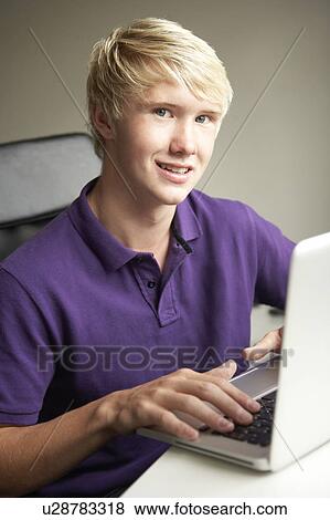 Teenage Boy Using Laptop At Home View Large Photo Image Stock Photo - Teenage Boy Using Laptop At Home. Fotosearch