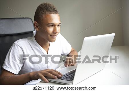 Teenage Boy Using Laptop At Home View Large Photo Image Stock Photograph - Teenage Boy Using Laptop At Home. Fotosearch