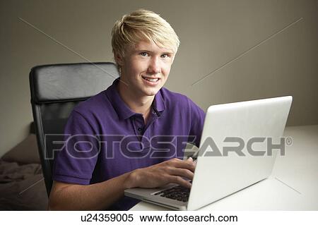 Teenage Boy Using Laptop At Home View Large Photo Image Stock Photography - Teenage Boy Using Laptop At Home. Fotosearch