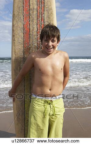 Teenage boy with surfboard View Large Photo Image Stock Photo - Teenage boy with surfboard. Fotosearch