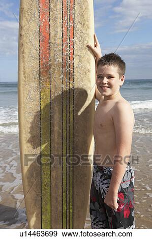 Teenage boy with surfboard View Large Photo Image Stock Photo - Teenage boy with surfboard. Fotosearch