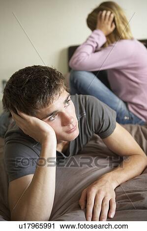 Stock Image - Teenage Couple In Bedroom After Argument. Fotosearch