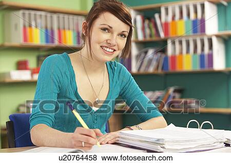 Stock Photo - Teenage Female Student In Working In Classroom. Fotosearch