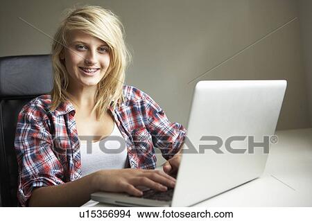 Picture - Teenage Girl Using Laptop At Home. Fotosearch
