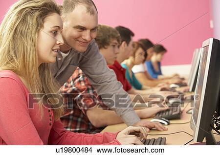 Teenage Students In IT Class Using Computers In Classroom With T View Large Photo Image Picture - Teenage Students In IT Class Using Computers In Classroom With T. Fotosearch