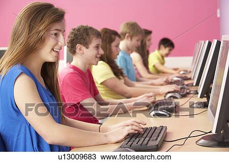 Stock Image - Teenage Students In IT Class Using Computers In Classroom. Fotosearch