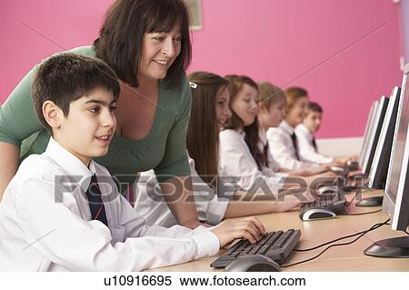 Stock Photography - Teenage Students In IT Class Using Computers In Classroom With T. Fotosearch