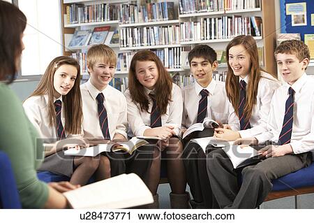 Teenage Students In Library Reading Books With Tutor View Large Photo Image Stock Image - Teenage Students In Library Reading Books With Tutor. Fotosearch