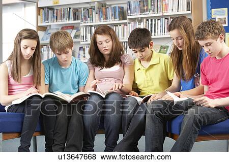 Teenage Students In Library Reading Books View Large Photo Image Stock Photo - Teenage Students In Library Reading Books. Fotosearch