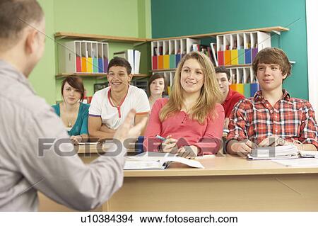 Picture - Teenage Students Studying In Classroom With Tutor. Fotosearch