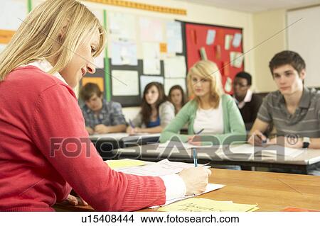 Picture - Teenage Students Studying In Classroom With Teacher. Fotosearch