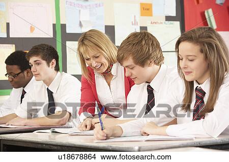Picture - Teenage Students Studying In Classroom With Teacher. Fotosearch