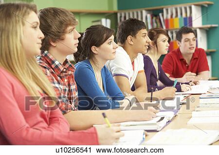 Stock Image - Teenage Students Studying In Classroom. Fotosearch