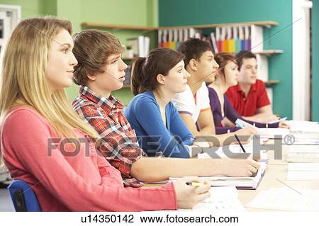 Stock Image - Teenage Students Studying In Classroom. Fotosearch